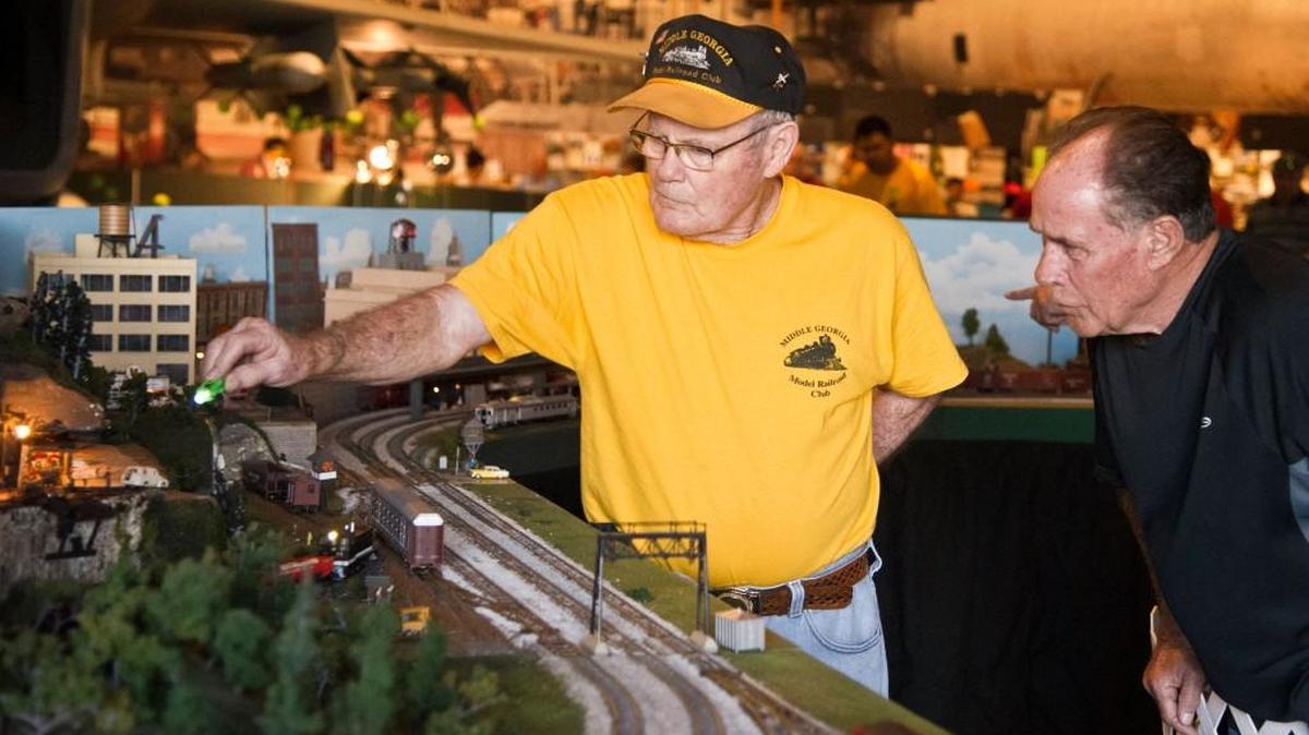 Middle Georgia Model Railroad Club member Ron Hinton points out some the highlights of a set he made to Edward Bell at the Museum of Aviation Friday, Nov. 25, 2016. The Middle Georgia Model Railroad Club set up track in the Eagle Building. This year’s event will be held Nov. 18-26 at the Museum of Aviation.