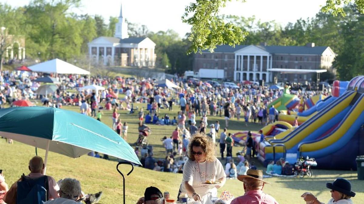 Debbie King serves herself a picnic dinner from a a shaded promontory where the music was good and the fireworks view even better as she and family members closed out the Cherry Blossom Festival last year at Wesleyan College.