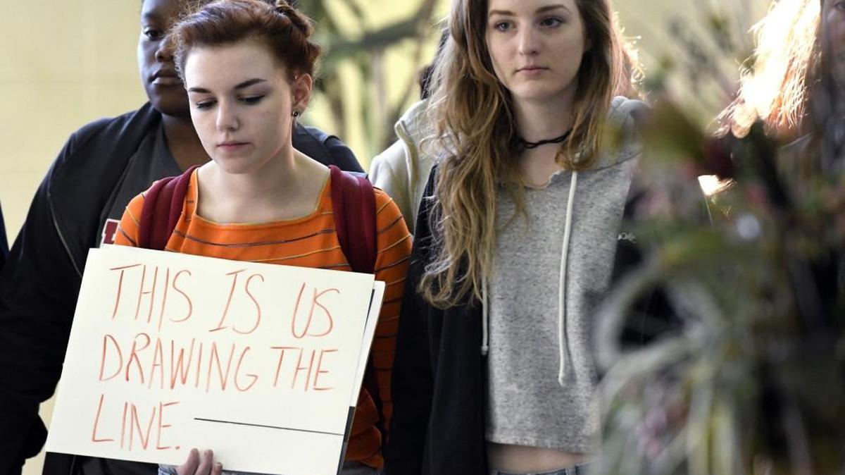 Howard High School students stand in silence in the School’s atrium while participating in the National School Walkout on March 14.