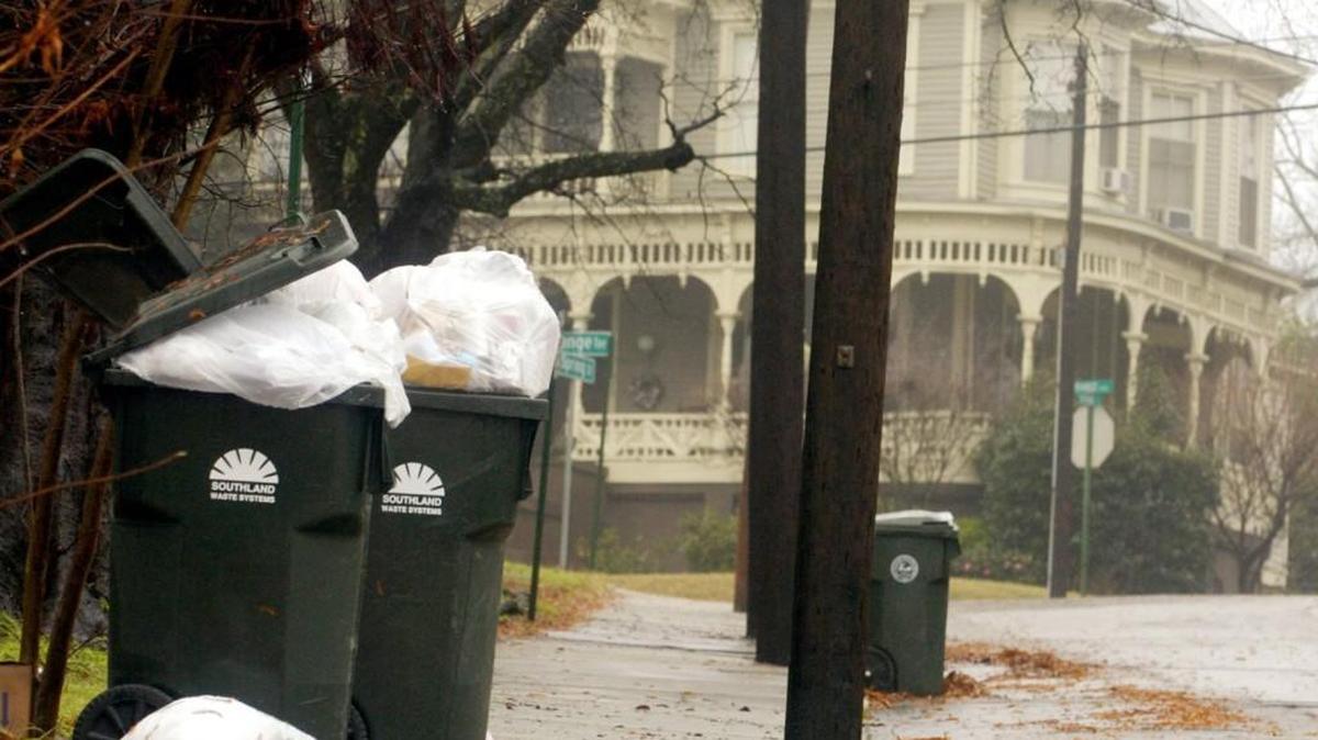 Trash overflows a couple of garbage cans along Spring Street in Macon in this file photo.