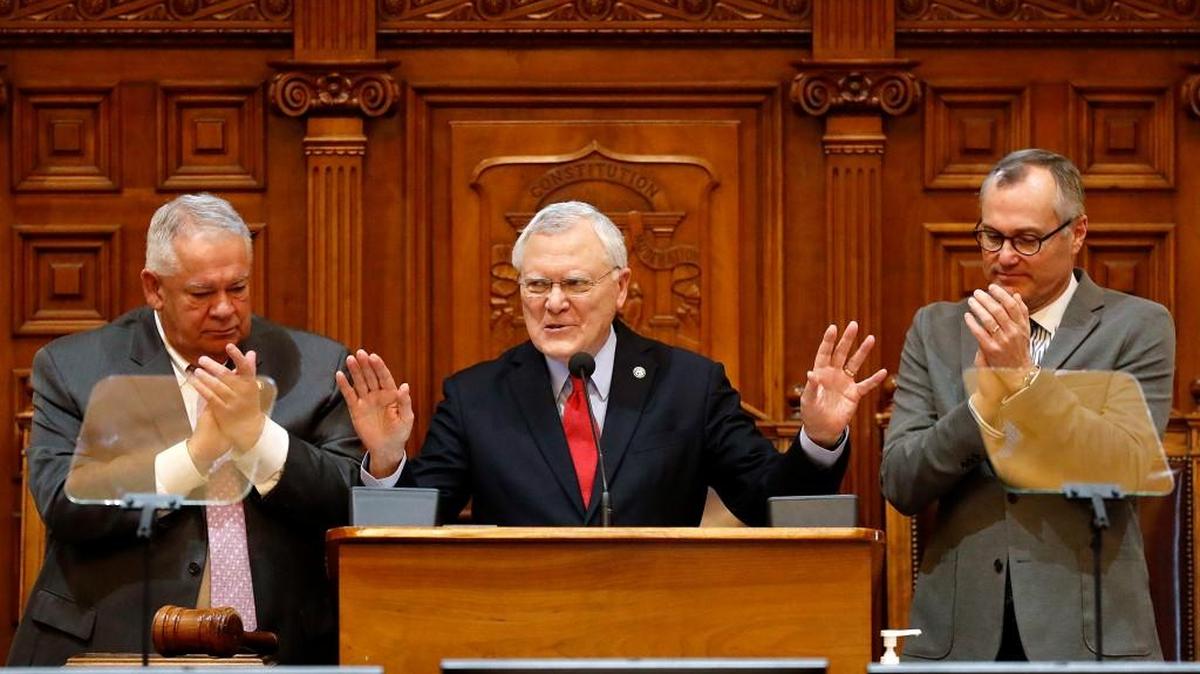 Georgia Gov. Nathan Deal delivers the State of the State address on the House floor while applauded by Lt. Gov. Casey Cagle, right, and House Speaker David Ralston at the state Capitol in Atlanta, Thursday, Jan. 11, 2018.
