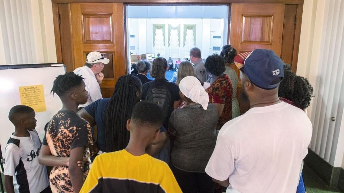 Macon-Bibb County citizens stand outside the commission chamber during a commission meeting Tuesday night to vote on restoring funding for public transit, libraries, parks and recreation and outside agencies.