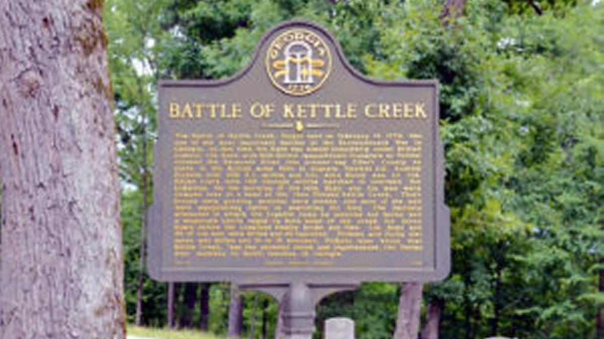 Marker Text: The Battle of Kettle Creek, fought here on February 14, 1779, was one of the most important battles of the Revolutionary War in Georgia. At that time, the State was almost completely under British control. Col. Boyd with 600 British sympathizers (Loyalists or Tories) crossed the Savannah River into present day Elbert County en route to the British Army then at Augusta. Patriots Col. Andrew Pickens with 200 S.C. militia and Col. John Dooly and Lt. Col. Elijah Clark with 140 Georgia Militia marched to overtake the Loyalists. On the morning of the 14th, Boyd and his men were camped here at a bend in the then flooded Kettle Creek. Their horses were grazing, sentries were posted, and most of the men were slaughtering cattle or searching for food. The Patriots attempted to attack the Loyalist camp by surprise but failed and a desperate battle raged on both sides of the creek for three hours before the Loyalists finally broke and fled. Col. Boyd and 20 of his men were killed and 22 captured. Pickens and Dooly lost seven killed and 14 or 15 wounded. Pickens later wrote that Kettle Creek “was the severest check and chastisement, the Tories ever received in South Carolina or Georgia.”