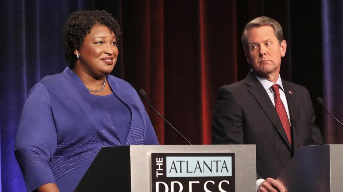 Democratic gubernatorial candidate for Georgia Stacey Abrams, left, speaks as her Republican opponent Secretary of State Brian Kemp looks on during a debate Tuesday in Atlanta.