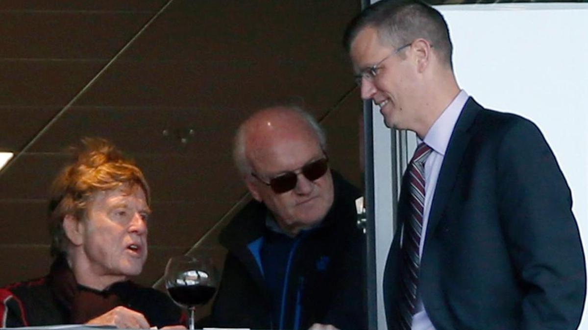 Robert Redford, left, journalist Mike Barnicle, center, and Boston Red Sox president Sam Kennedy talk during a 2016 game.