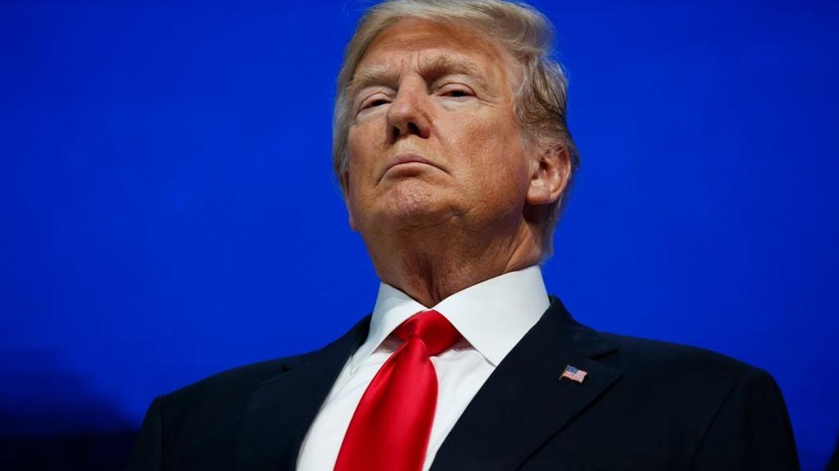 President Donald Trump listens as he is introduced to deliver a speech to the World Economic Forum, Friday, Jan. 26, 2018, in Davos.