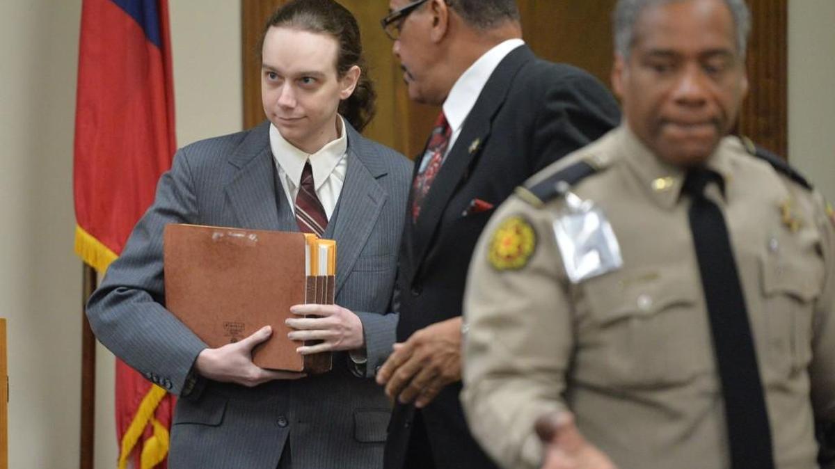 In this 2013 file photo, Stephen McDaniel left carries files as he makes his way to a hearing in connection with charges he murdered fellow law student Lauren Giddings.