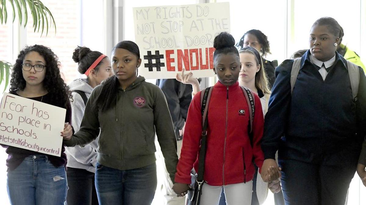 Howard High School students stand in silence in the school’s atrium while participating in the National School Walkout on Wednesday morning.
