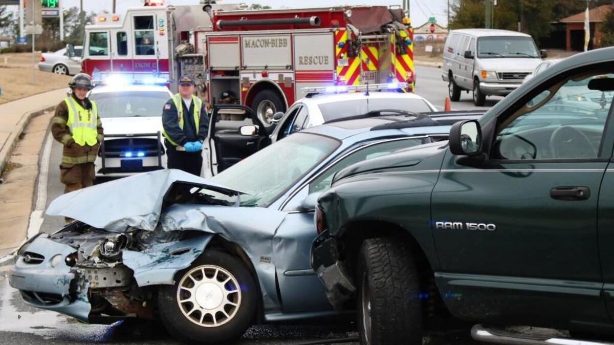 Macon-Bibb County firefighters wait for a crash to be cleared at Log Cabin Drive at Eisenhower Parkway. Bibb County Sheriff's deputies on the scene said the accident happened after the driver of a Dodge pickup refused to stop for an officer.