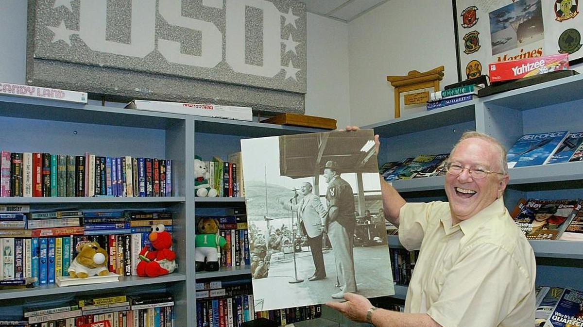 Michael Tielmann, a retired brigadier general with the National Guard, holds up a picture of entertainer Bob Hope entertaining U.S. troops in Vietnam in 1968.