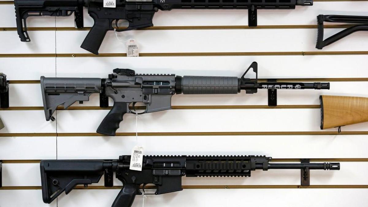 A Ruger AR-15 semi-automatic rifle, center, the same model, though in gray rather than black, used by the shooter in a Texas church massacre.
