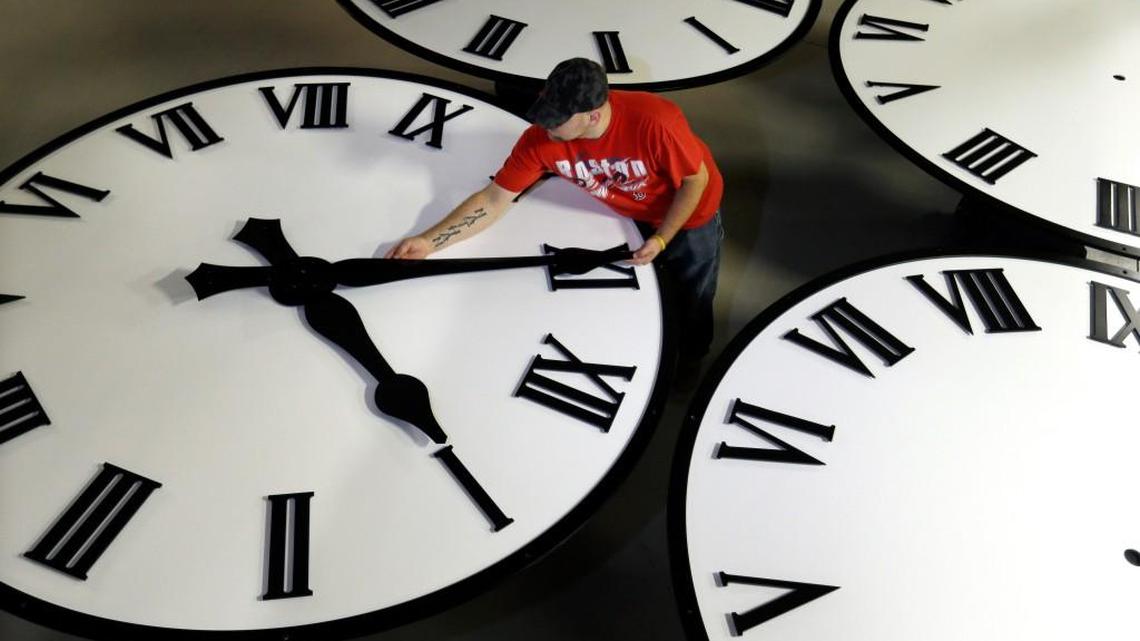 Dan LaMoore sizes hands for an 8-foot diameter silhouette clock at Electric Time Co., in Medfield, Mass. Daylight saving time ends at 2 a.m. local time Sunday, when clocks are set back one hour.