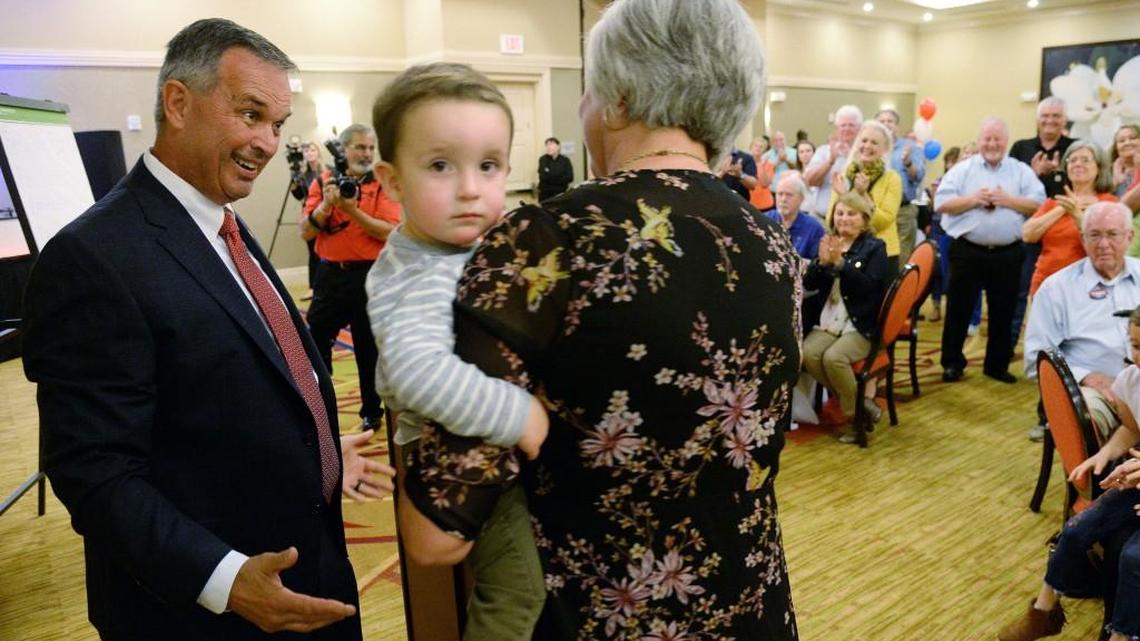 Warner Robins Mayor Randy Toms looks over at his wife Jane while she holds their grandson Campbell, 2, after final results from Tuesday's election were announced at a campaign party.