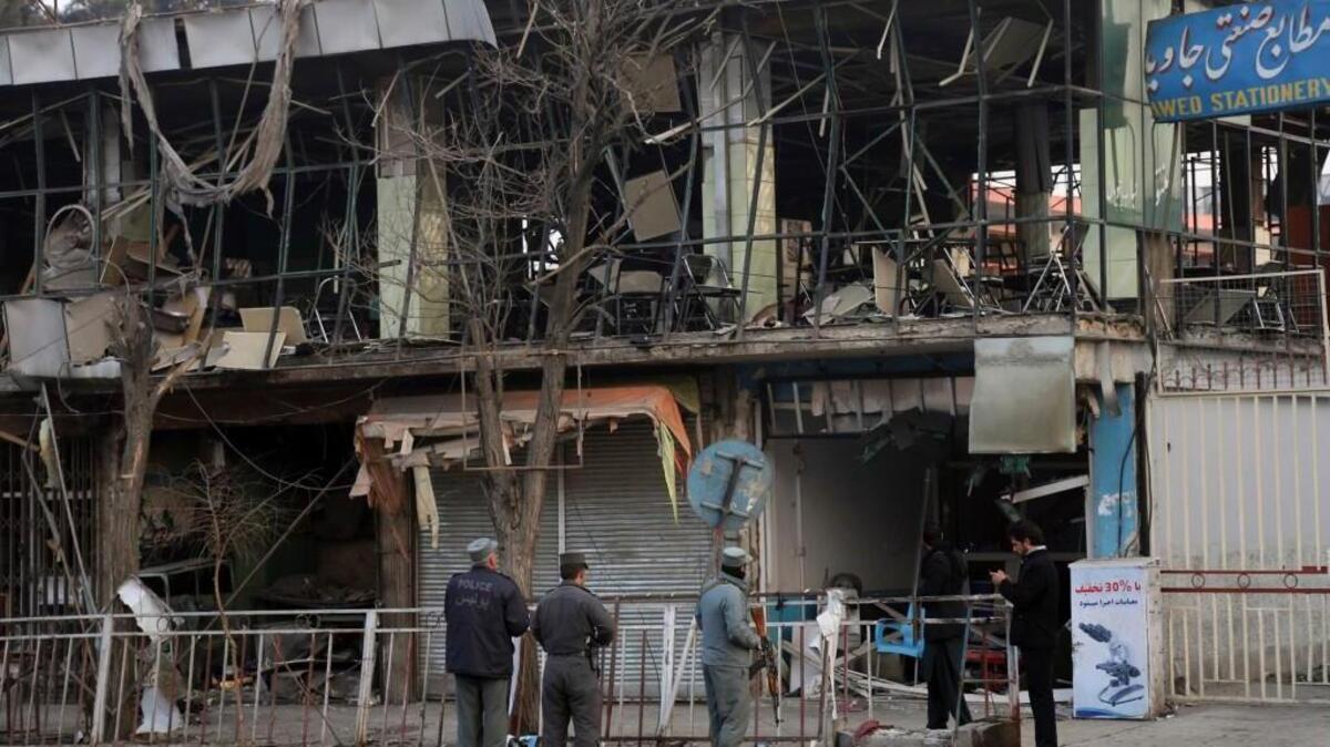 Members of Afghan security forces stand guard at the site of a Saturday suicide attack claimed by the Taliban in Kabul, Afghanistan.