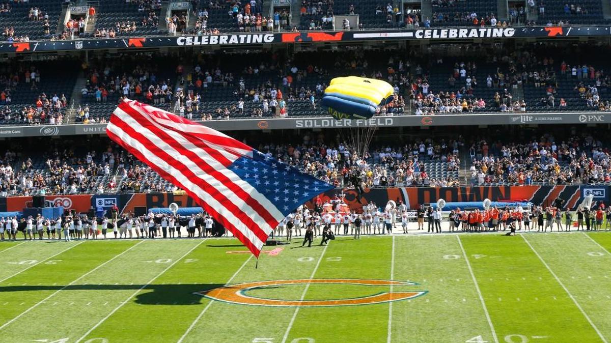 A Navy parachutist lands at Soldier Field during pregame ceremonies before an NFL football game between the Chicago Bears and Pittsburgh Steelers.