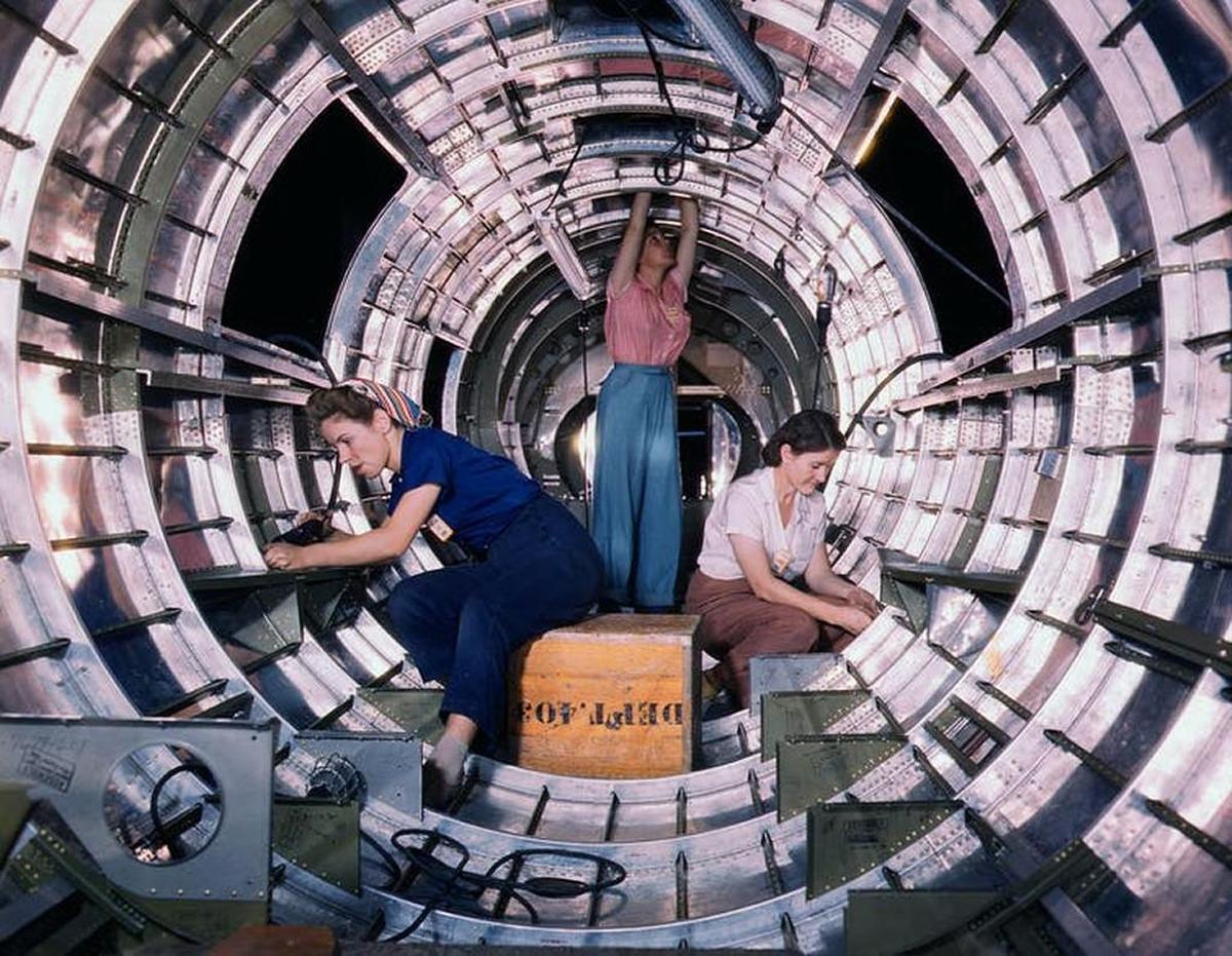 Workers install fixtures and assemblies to a B-17 tail fuselage at the Douglas Aircraft Company plant in Long Beach.