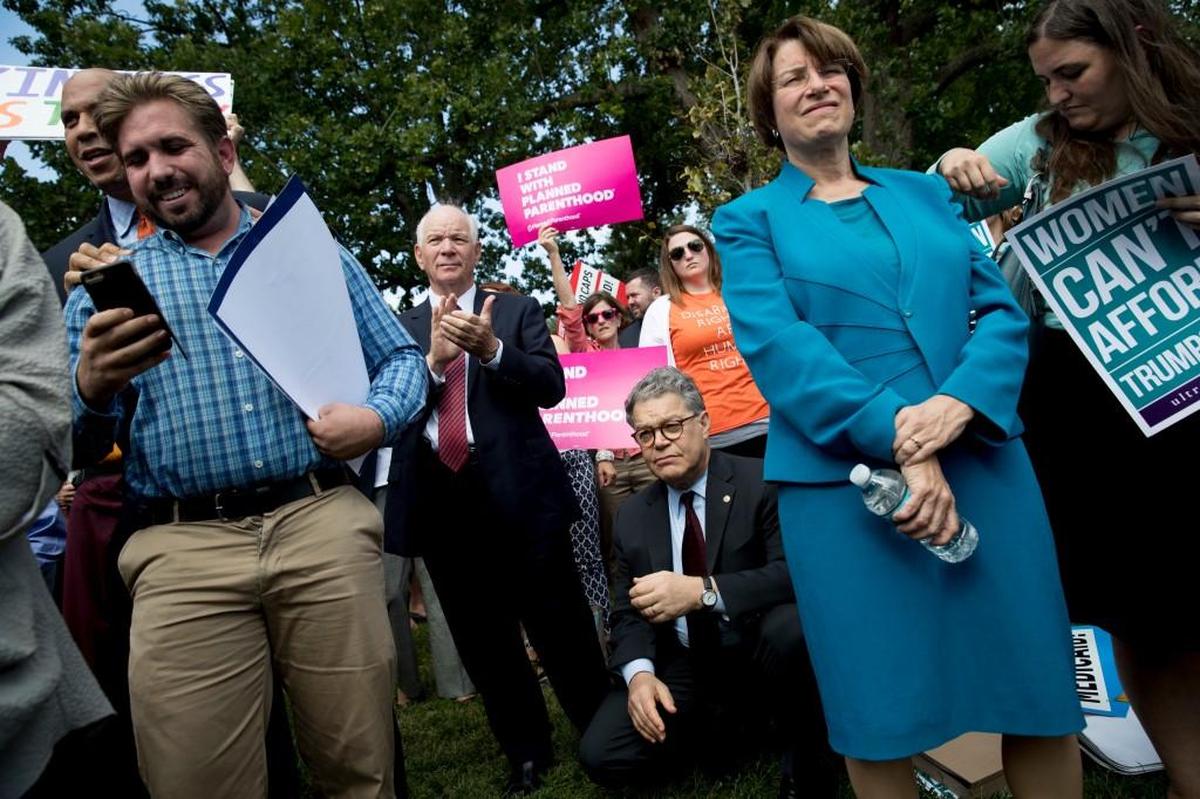 From left, Sen. Cory Booker, D-N.J., Sen. Ben Cardin, D-Md., Sen. Al Franken, D-Minn., and Sen. Amy Klobuchar, D-Minn., stand with health care advocates, grassroots activists, and concerned constituents at a rally outside the Capitol in Washington, Tuesday, Sept. 19, 2017. Senate Republicans begin another push to repeal the Affordable Care Act with the Graham-Cassidy proposal.
