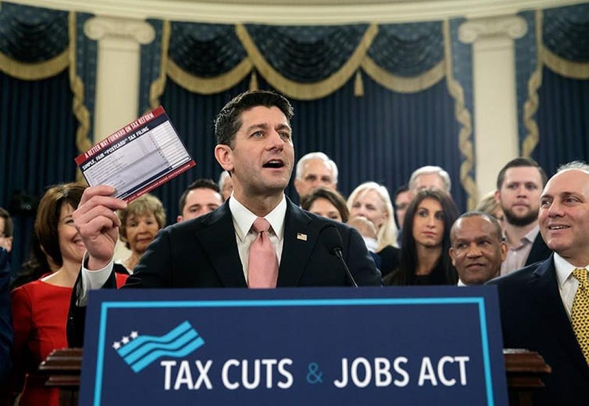 Speaker of the House Paul Ryan holds a proposed ‘postcard tax filing form.’