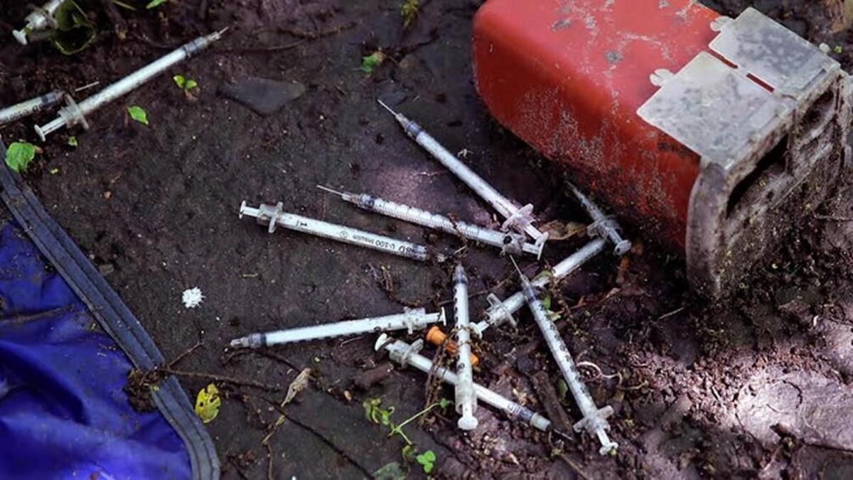 Discarded used hypodermic needles along the Merrimack River in Lowell, Massachusetts.