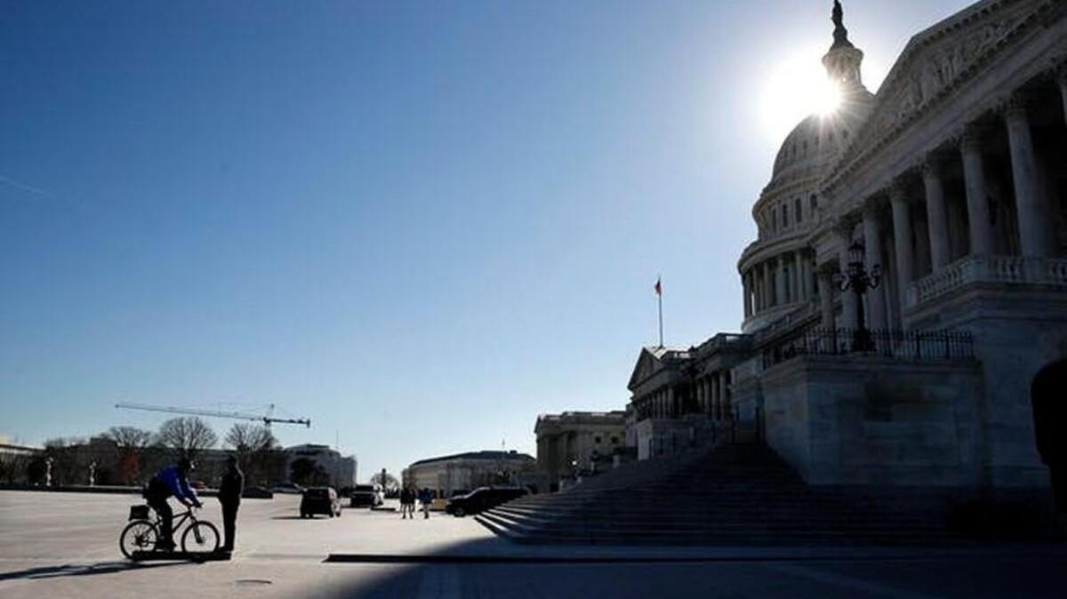 The sun casts a shadow over the Capitol on Friday, Jan. 19.