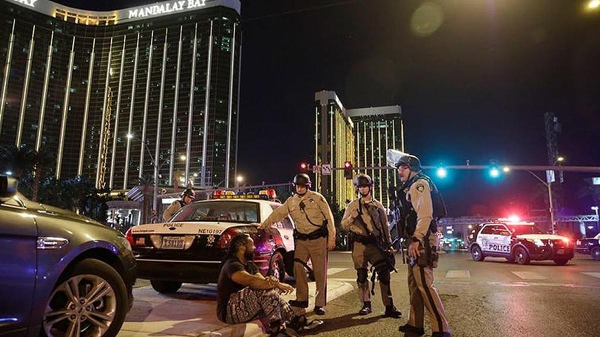 Police officers stand at the scene of a shooting near the Mandalay Bay resort and casino on the Las Vegas Strip.