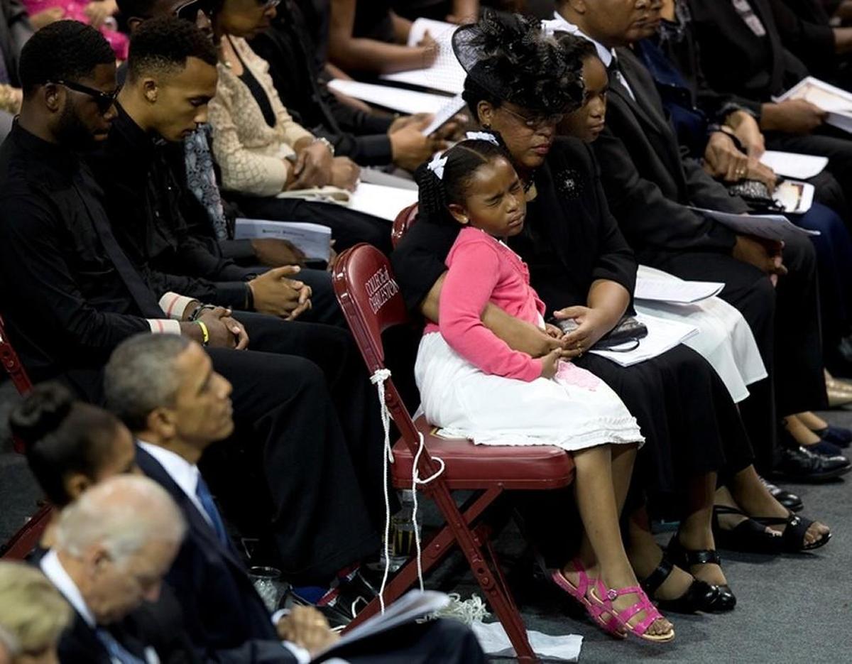 The widow of Clementa Pinckney, a pastor and South Carolina lawmaker slain in the mass murder at Charleston’s Mother Emanuel African Methodist Episcopal Church, hugs her daughter during a 2015 memorial service for victims of that attack.