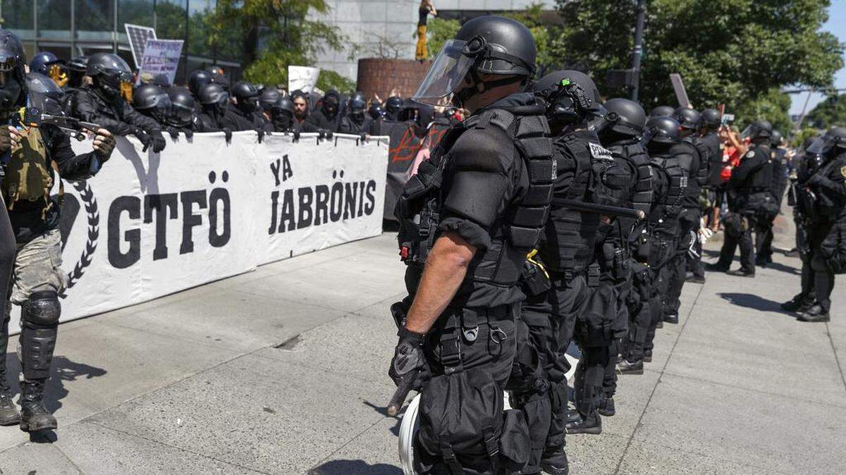Portland police keep Patriot Prayer affiliates separate from antifa protesters during a rally in Portland, Ore., last year.