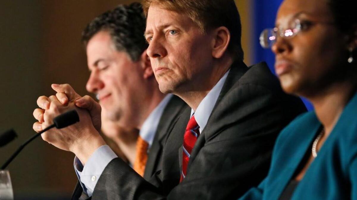 Consumer Financial Protection Bureau Director Richard Cordray, center, listens to comments during a panel discussion in Richmond, Va. On Tuesday, Oct. 11, 2016, a federal appeals court ruled that the way the CFPB is organized violates the Constitution’s separation of powers by limiting the president’s ability to remove the director who heads the agency. Cordray, a Democrat and former Ohio attorney general, has run the agency since it began operating in July 2011.