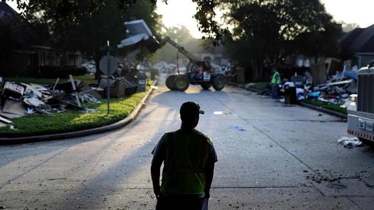 Crews clean up debris in a neighborhood flooded by Hurricane Harvey in Beaumont, Texas, Sept. 26, 2017.