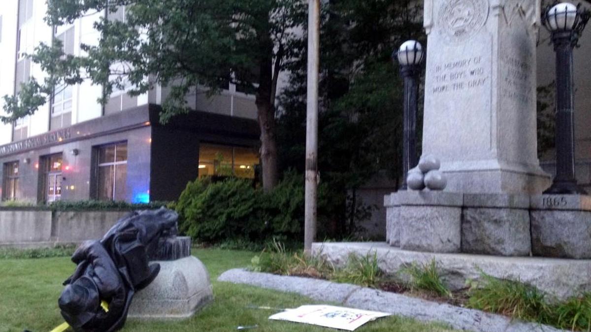 A toppled Confederate statue lies on the ground on Monday, Aug. 14, 2017, in Durham, N.C. Activists on Monday evening used a rope to pull down the monument outside a Durham courthouse. The Durham protest was in response to a white nationalist rally held in Charlottesville, Va, over the weekend. Authorities say one woman was killed Saturday after one of the white nationalists drove his car into a group of counterprotesters.