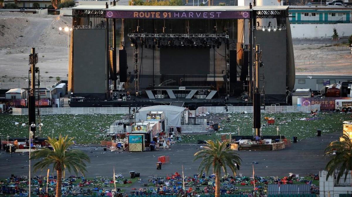 Debris litters a festival grounds across the street from the Mandalay Bay resort and casino Tuesday, Oct. 3, 2017, in Las Vegas. Authorities said Stephen Craig Paddock broke windows on the casino and began firing with a cache of weapons, killing dozens and injuring hundreds at a music festival at the grounds.