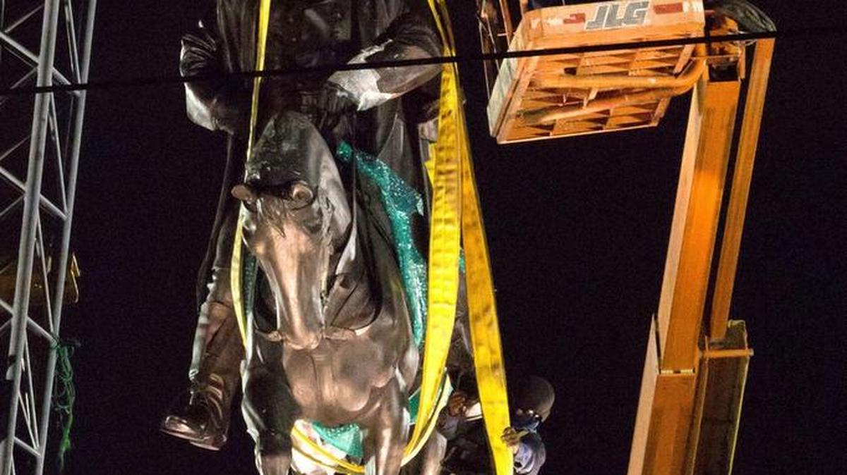 In this May 17, 2017, file photo, workers in protective gear attach straps to the statue of Confederate general P.G.T. Beauregard as it is prepared for removal from the entrance to City Park in New Orleans. State Rep. Patricia Smith, a black Baton Rouge Democrat, received 105 emails alone, almost all favoring a proposal by her Republican colleague Thomas Carmody that would have erected obstacles to tearing down such monuments.