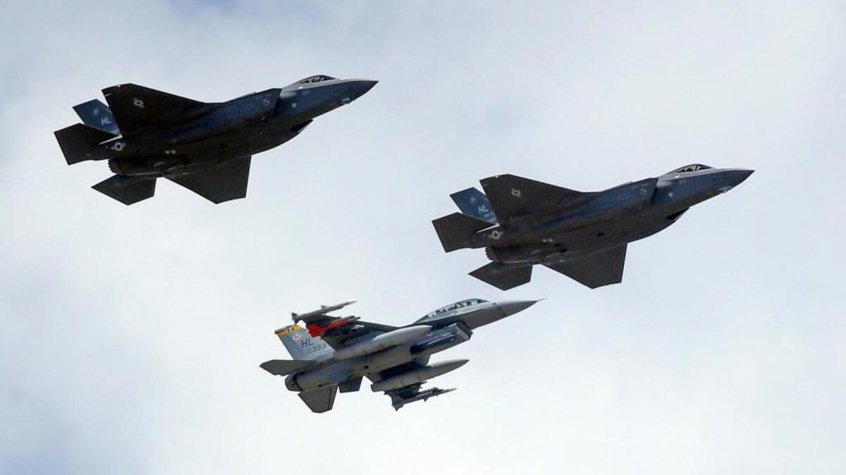 FILE - This file photo shows an F-16, below, escorting two F-35 jets, above, after arriving at Hill Air Force Base in Utah. The U.S. and its Asia-Pacific allies are rolling out their new stealth fighter jet, a cutting-edge plane that costs about $100 million each.