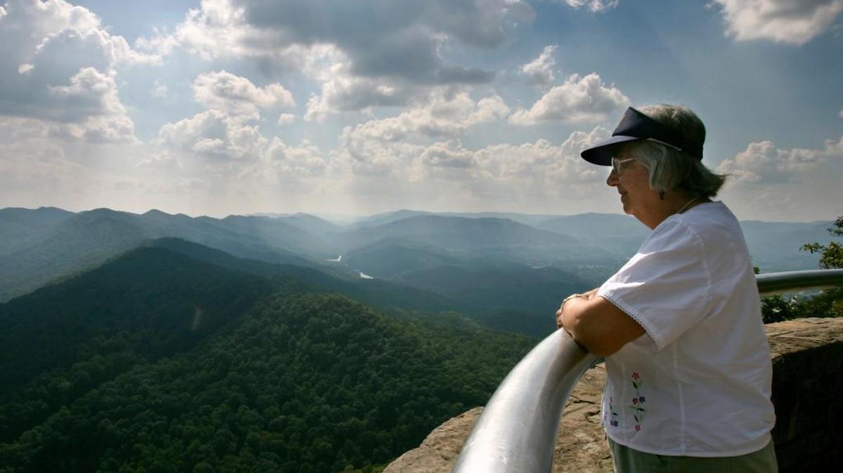 Rosemary Havill, of Lakeland, Florida, takes in the view at the Pinnacle Overlook at Cumberland Gap state park. Three states, Kentucky, Tennessee, and Virginia, are visible from the viewing deck.