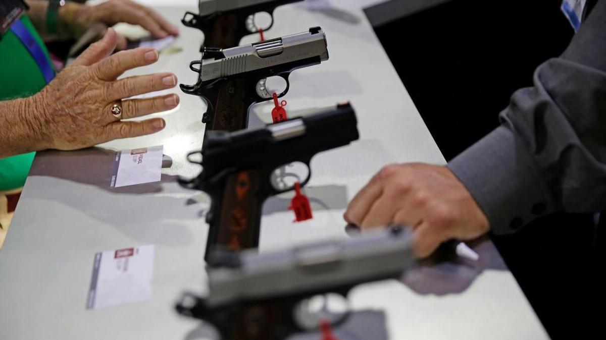 Guns sit on display at the NRA annual convention where President Donald Trump is scheduled to speak later in the day in Atlanta, Friday, April 28, 2017.