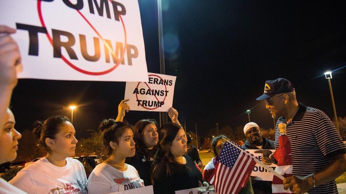 Former Macon Mayor C. Jack Ellis speaks with fellow protesters outside the Macon Coliseum prior to Republican presidential candidate Donald Trump's speech in 2015.