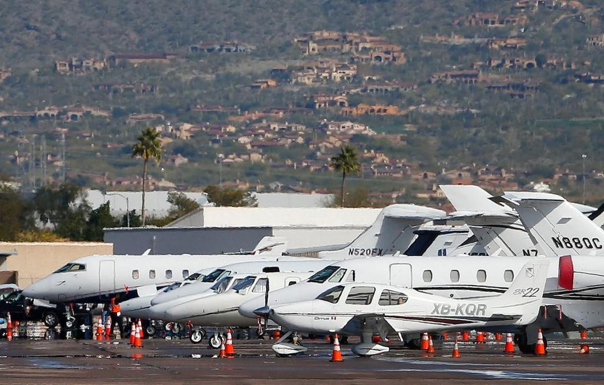 Private jets sit parked at Scottsdale Airport, in Scottsdale, Arizona.