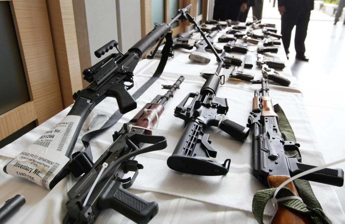 Various guns are displayed at the Chicago FBI office. A new poll shows most young adults across racial and ethnic groups support tighter gun polices including background checks, stricter penalties for gun law violations, and banning semi-automatic weapons.