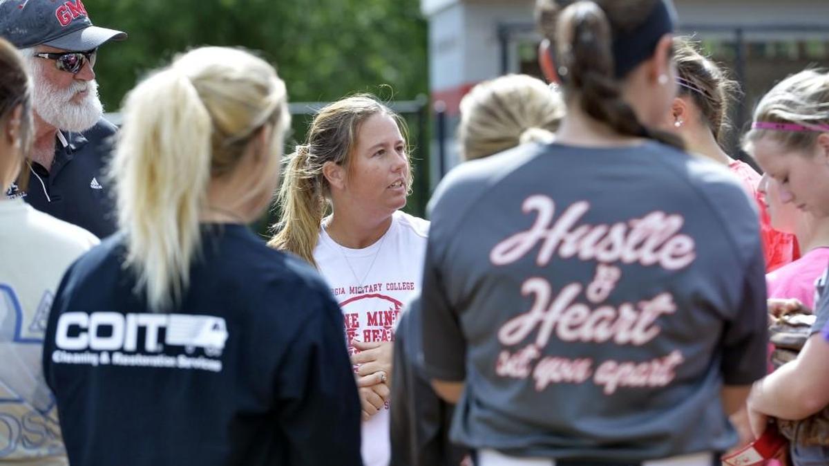 GMC coach Ashley Bunn, center, holds a team meeting at second base at the end of practice.