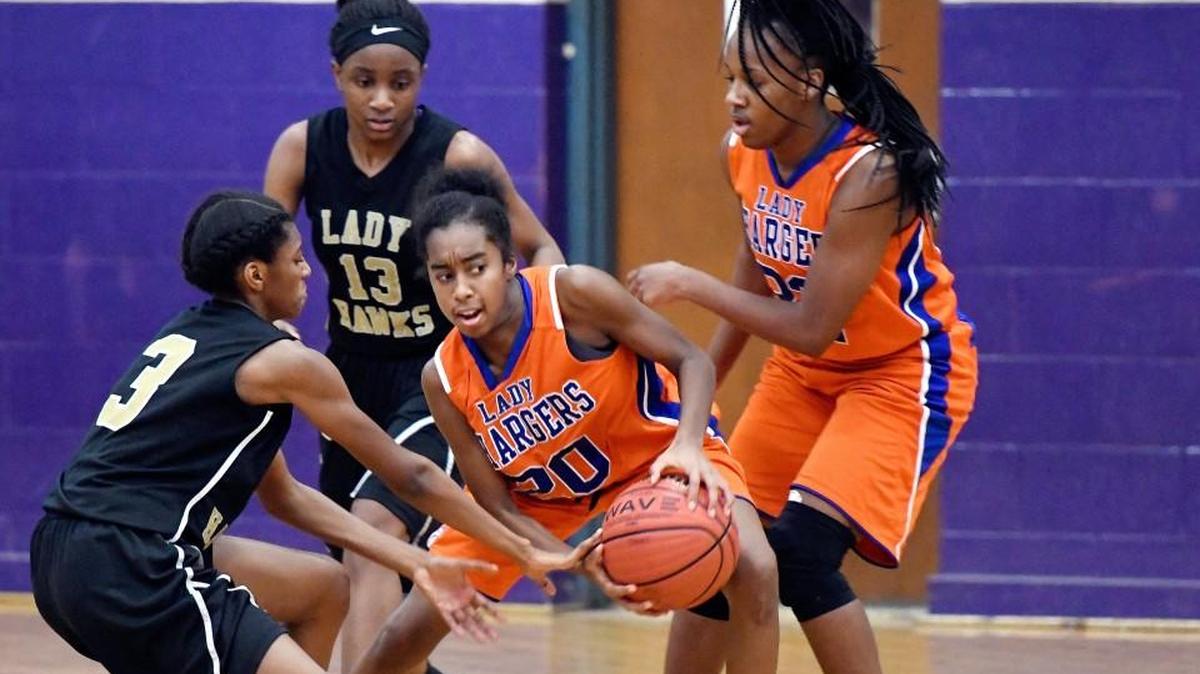 Central guard Zaren Harris (20) grabs a loose ball during the Chargers' game Friday night against Washington County.