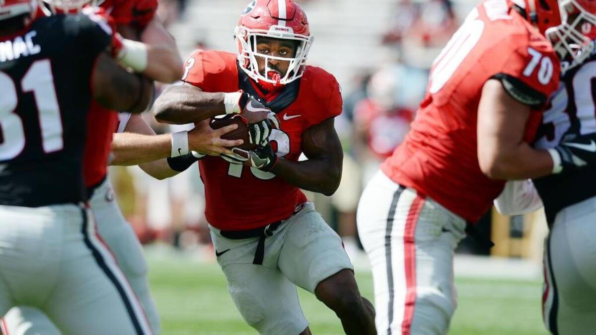 Elijah Holyfield (13) takes a hand off from Jake Fromm during second half action of the G-Day game.