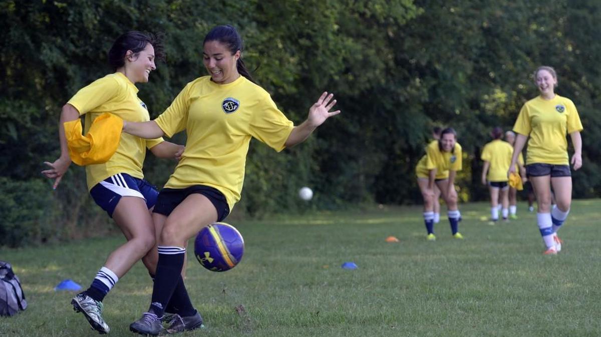 Reagan Cheney, left, and Anna Katherine Gregory collide during drills as their team practices Thursday.
