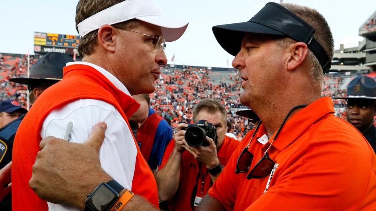 Auburn head coach Gus Malzahn, left, talks with Mercer head coach Bobby Lamb after Saturday’s game.