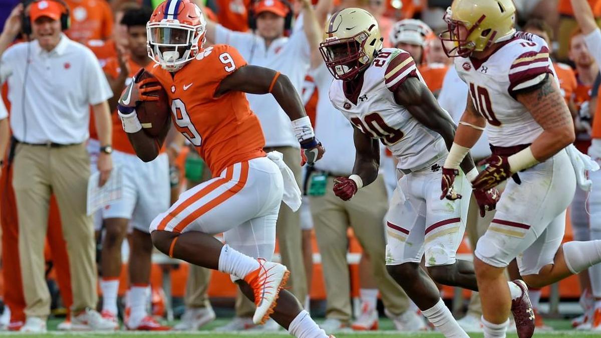 Clemson's Travis Etienne outruns Boston College's Isaac Yiadom, center, and Ty Schwab to score a 50 yard touchdown during the second half of an NCAA college football game Saturday, Sept. 23, 2017, in Clemson, S.C. Clemson won 34-7.