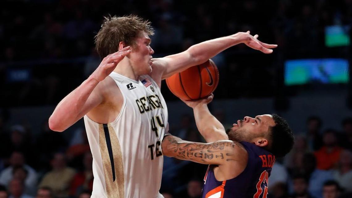 Clemson guard Avry Holmes (12) and Georgia Tech center Ben Lammers (44) battle for a rebound in the second half Thursday.