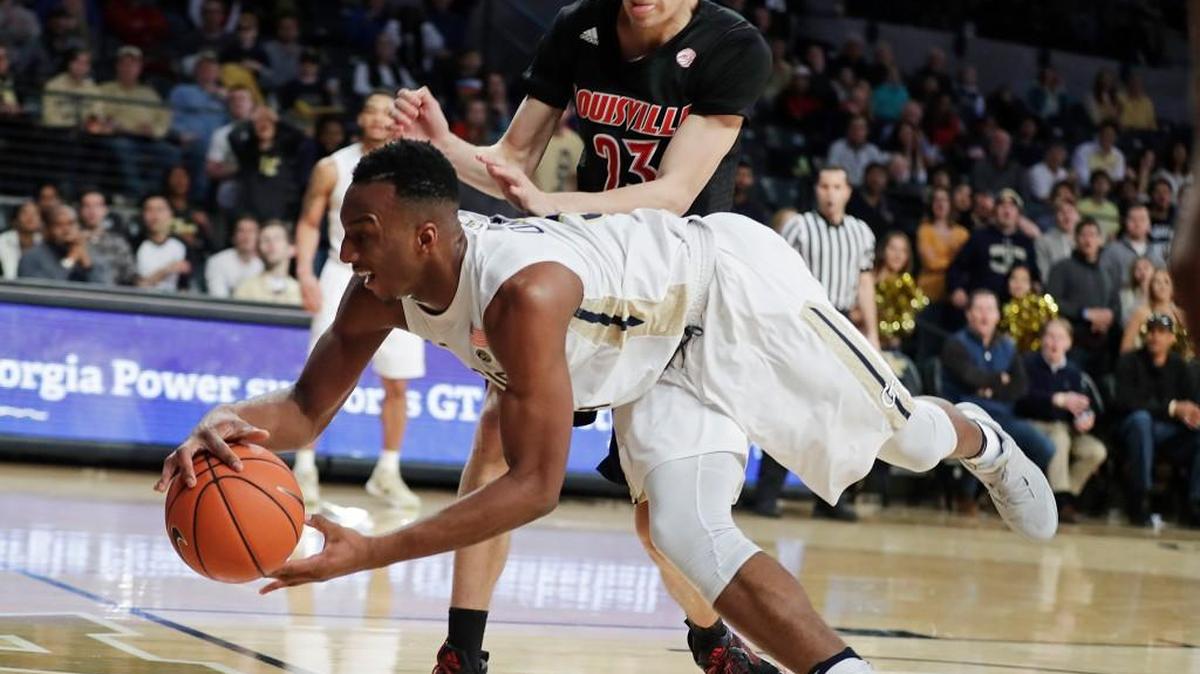 Georgia Tech's Josh Okogie, left, dives to keep a ball in play in front of Louisville's David Levitch in the second half of their game last Saturday. The Yellow Jackets host Clemson on Thursday.