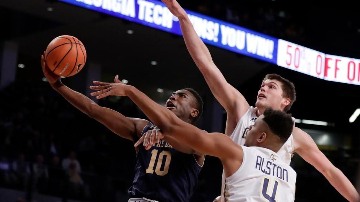 Georgia Tech’s Ben Lammers and Brandon Alston (4) defend Notre Dame guard TJ Gibbs (10) as he drives to the basket during the first half of their game Wednesday in Atlanta.