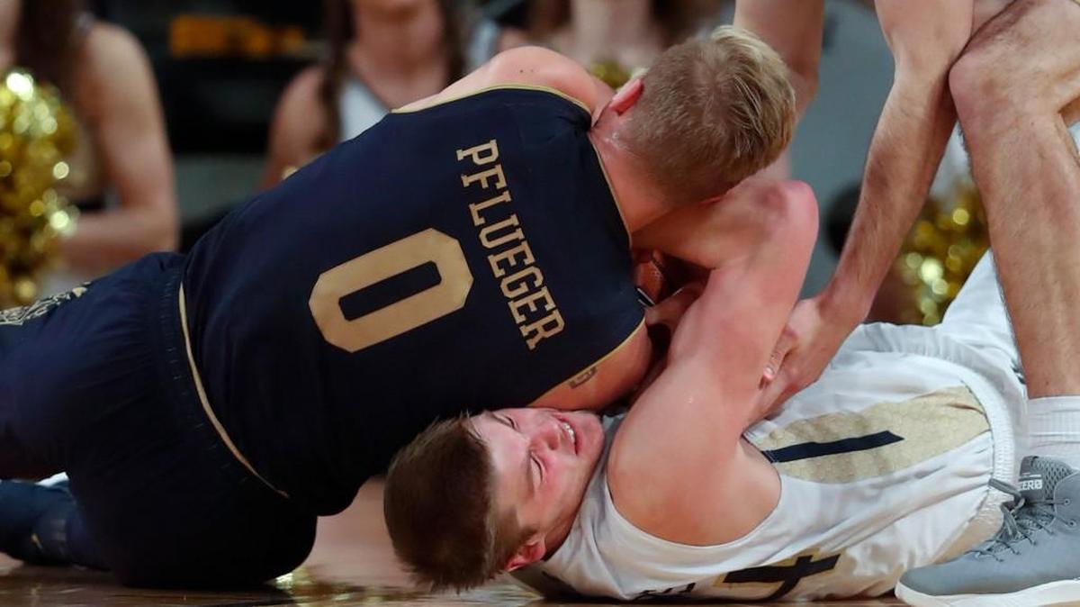 Georgia Tech center Ben Lammers (44) and Notre Dame guard Rex Pflueger (0) scrap for a loose ball during the first half of their game Wednesday in Atlanta.