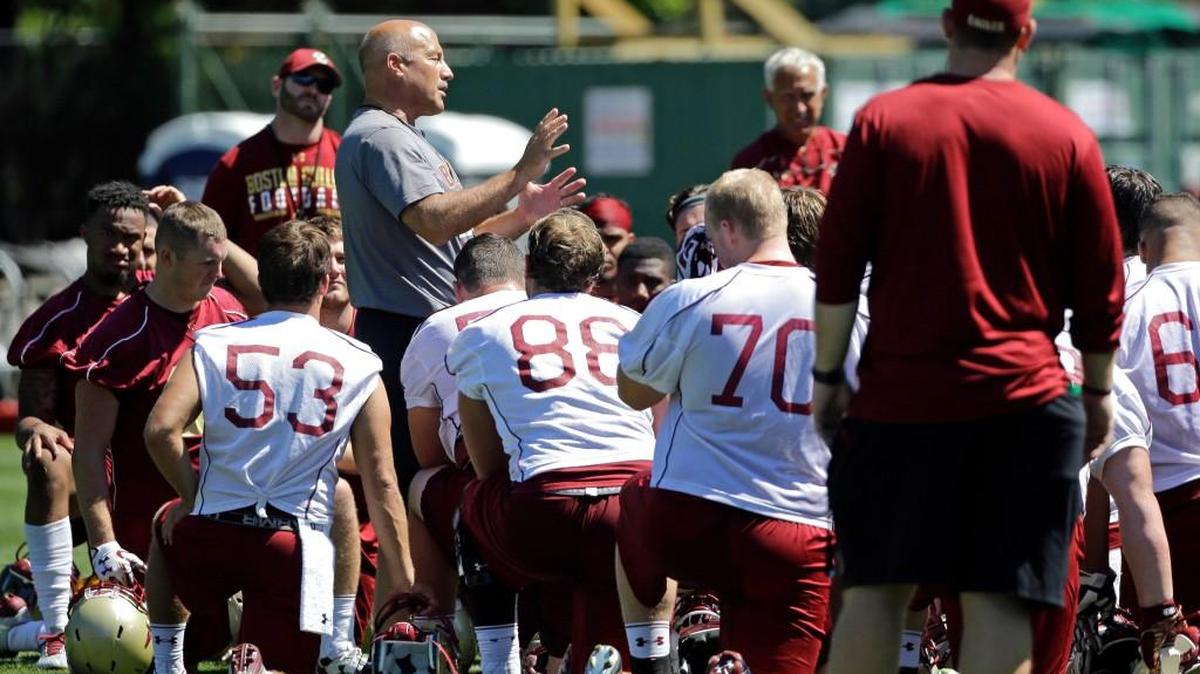 Boston College head coach Steve Addazio, left, speaks to his team during football practice this month.