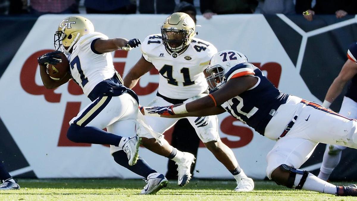 Georgia Tech’s Lance Austin, left, a Lamar County product, returns an interception for a touchdown during the fourth quarter Saturday against Virginia.
